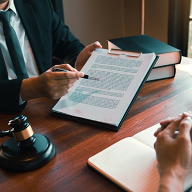lawyer pointing pen at contract