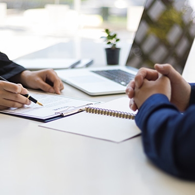 two people discussing papers